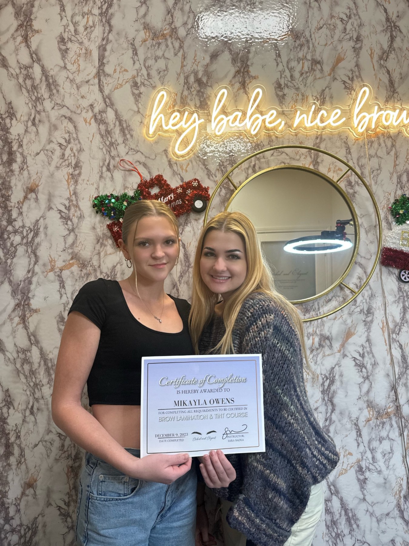 Sara with a brow lamination student and certificate